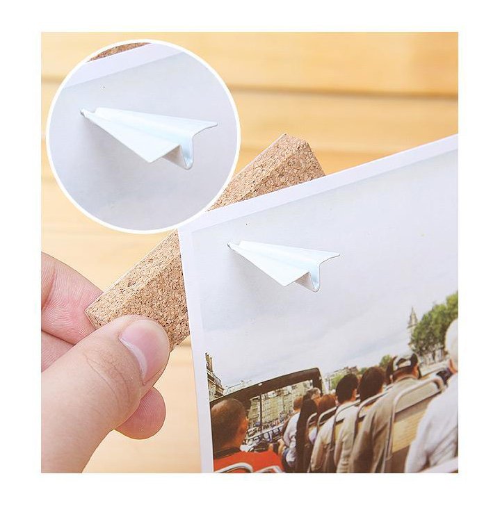 Paper airplane design pins on a bulletin board